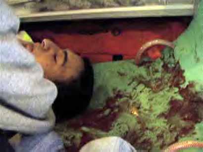 L'ambulancier Ihab Mansour, blessé, enchaîné sur son lit d'hôpital